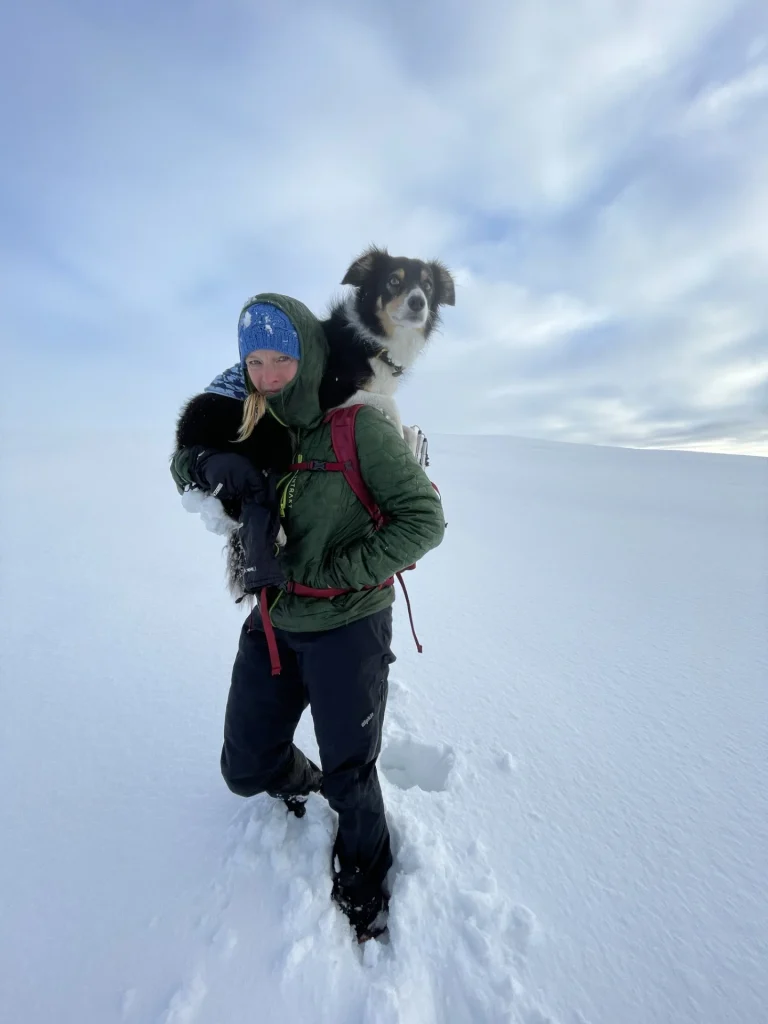 Ros and her dog Blea walking through deep snow in the Lake District