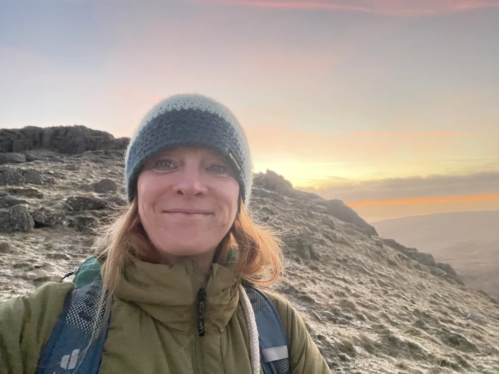 Ros on a Lake District summit in warm golden light