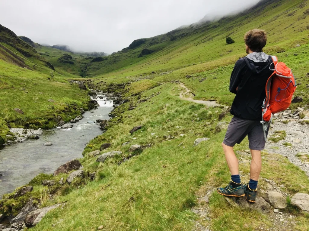 Walker beside the River Esk in Upper Eskdale