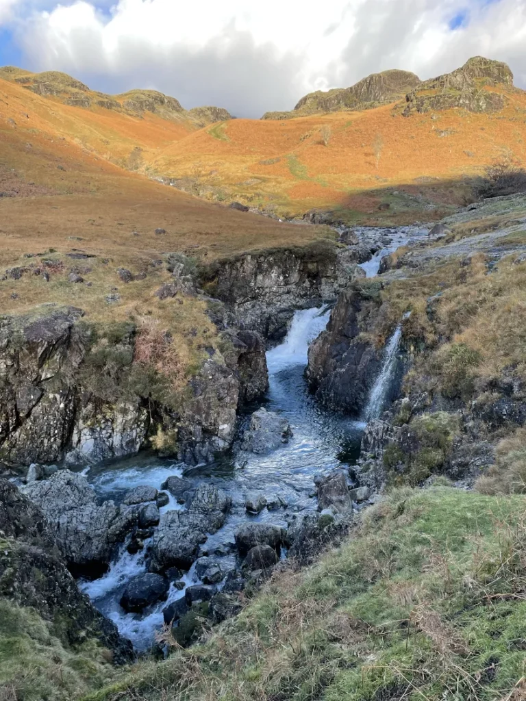 Small waterfall flowing through a rocky gorge in Upper Eskdale in the Western Lake District