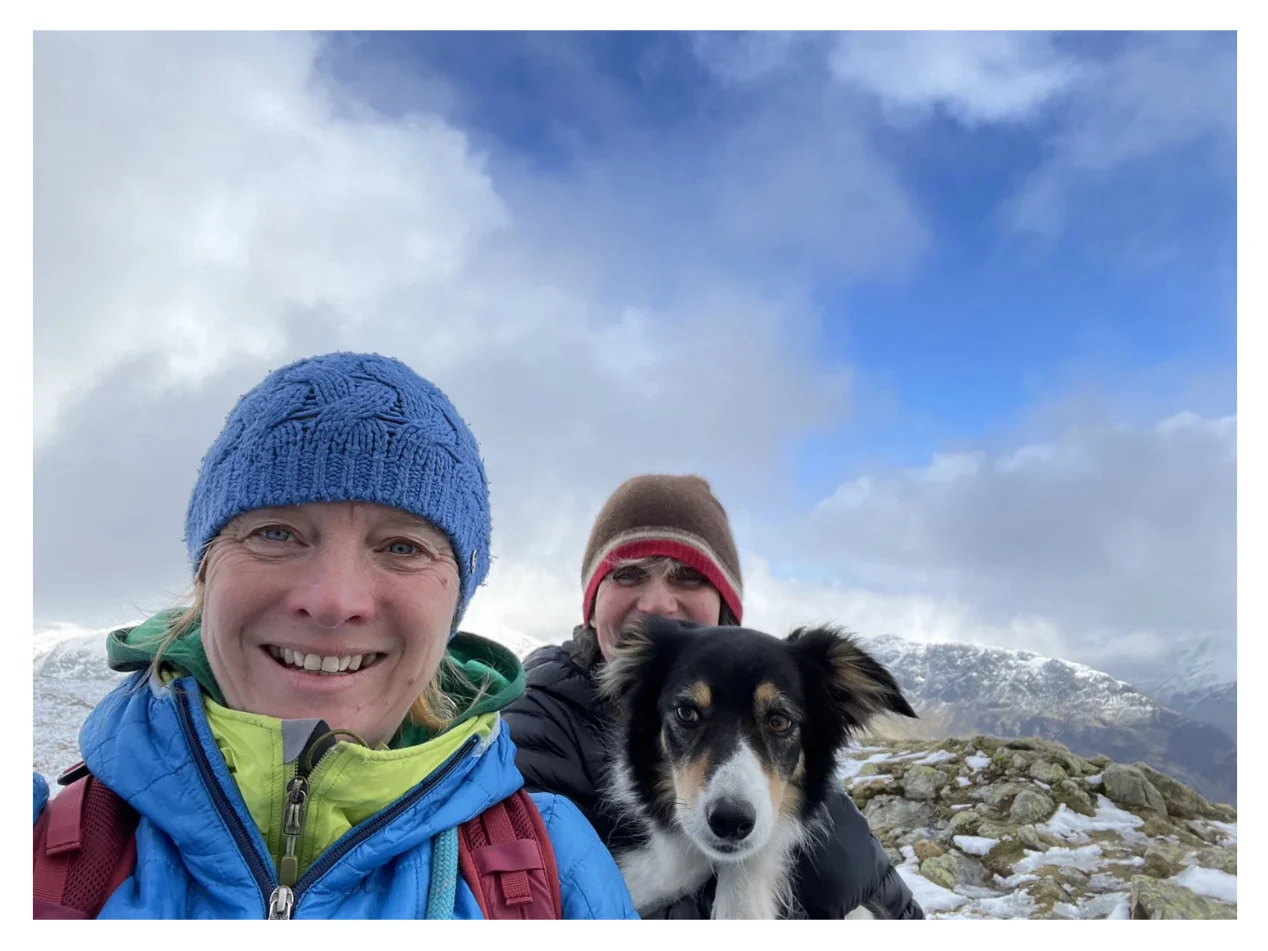 Ros and Blea the dog guiding a snowy Lake District mountain walk
