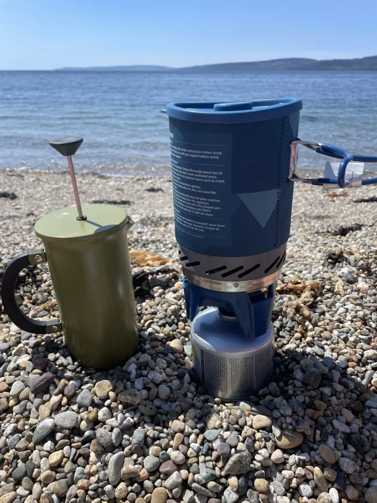 Outdoor camping stove making coffee by a Lake District lake