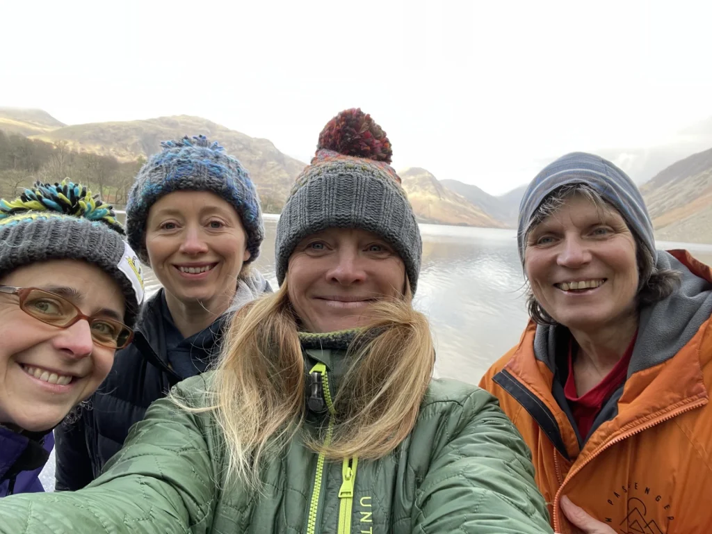 Women Only Walkers smiling beside a lake in the Lake District